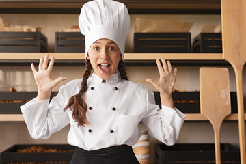 Excited little baker with dirty hands