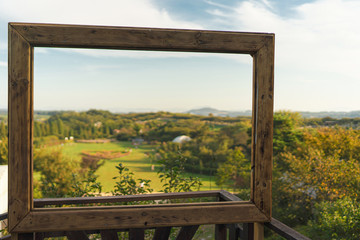 Fototapeta premium Beautiful landscape view in antique wood picture frame.