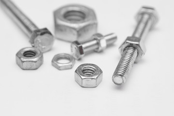 Selective focus of Many nuts and bolts on  white background