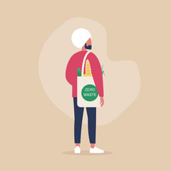 Zero waste concept, young indian male millennial character carrying groceries in a reusable eco friendly shopper bag