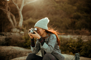 Asian woman drinking coffee on the mountain in sunset time camping travel concept