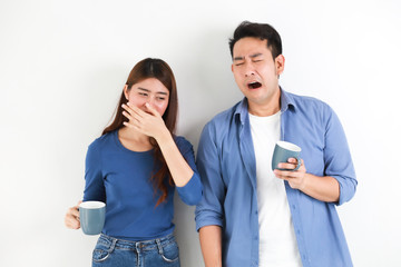 Asian couple in blue shirt on white background with cup of coffee happy and smile mood