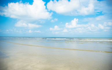 Beautiful beach, sea water, clear sky at morning with gentle wind waves. Concept for a nice holiday vacation.