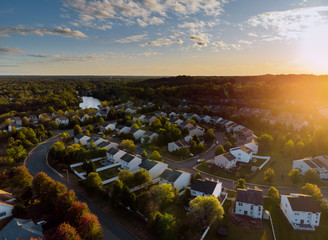 Dawn in the sleeping area of a small town with a forest on the view from a height