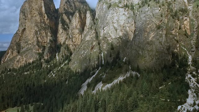 Imposing peaks in the Italian Dolomites. Flight along the rock face of the beautiful alpine  Vallunga / Langental.