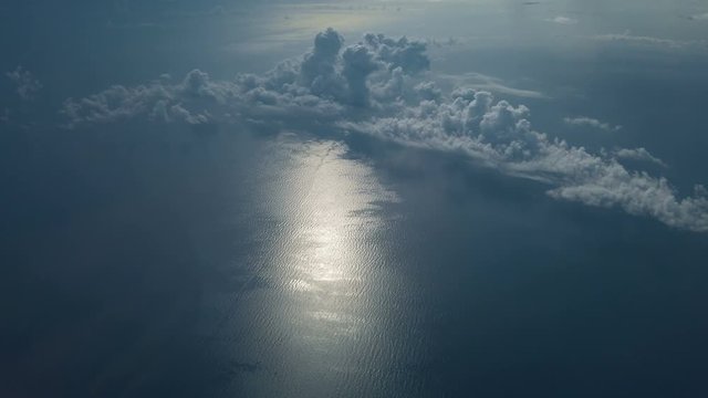 View Out Of  The Window From Airplane Above The White Clouds Flying Over Gulf of Mexico.