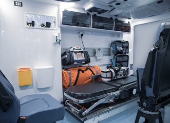 Interior of an ambulance with bed and patient medical care first aid equipment