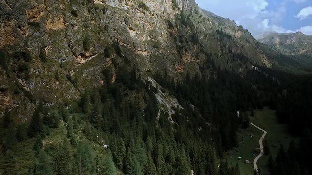 The beautiful Langental, also called Vallunga, near Wolkenstein im Gr&ouml;den. Majestic, towering cliffs and green meadows, dotted with dark spruce forest.