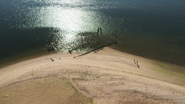aerial drone camera orbit right over Shell Bank Creek in Brooklyn, with the creek shore & water in view with fisherman & his kid part 1