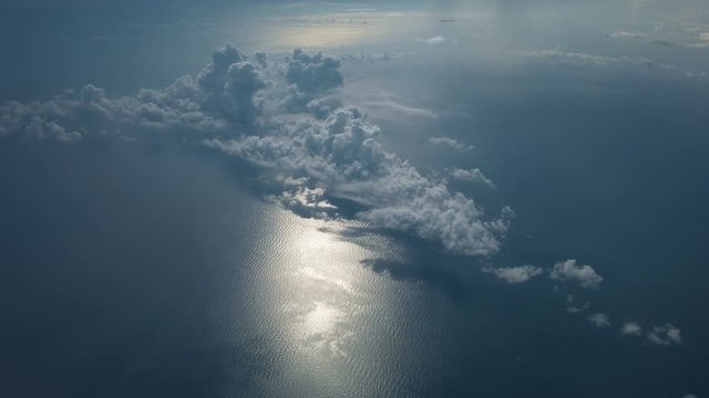 View Out Of  The Window From Airplane Above The White Clouds Formation Flying Over Gulf of Mexico.