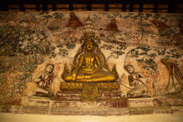 buddha statue on wall in temple .
