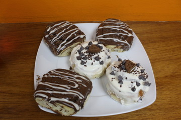 Sweet rolls of white cream and chocolate