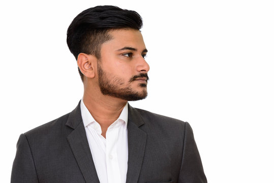 Side view of young handsome Indian businessman