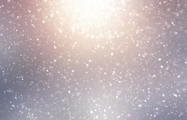 Snowfall shimmer on silver nature background. Shiny winter illustration. Lens flare outdoor.