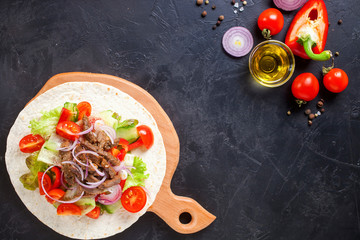 Tacos with Vegetables and Meat against a dark Background. Selective Focus. Top View. Copy Space