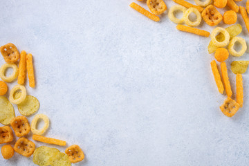 Chips, snacks on a light background. Top view. Copy space