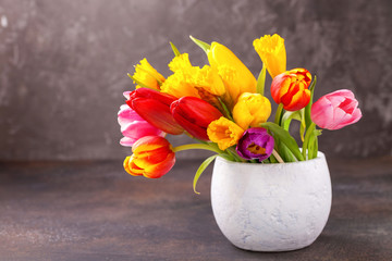 Bouquet of tulips in a vase. Selective focus.  Copy space