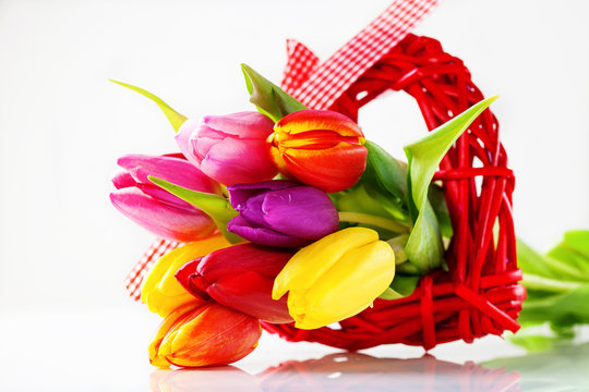 Bouquet of tulips and box with a gift for a holiday. Flower background. The image is isolated. Selective focus. Copy space