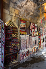 Fototapeta na wymiar Street bazaar of ancient oriental handmade Garabagh, Tabriz, Shirvan style carpets, rugs at Old Town Baku, Azerbaijan