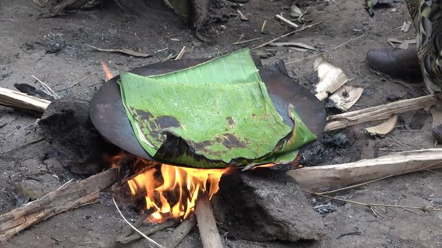 Cooking bread cakes on fire in the Ethiopian Dorsi tribe.