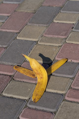 Banana peel was left on the pavement. The danger may slip. If anyone walks on it. Be careful of...