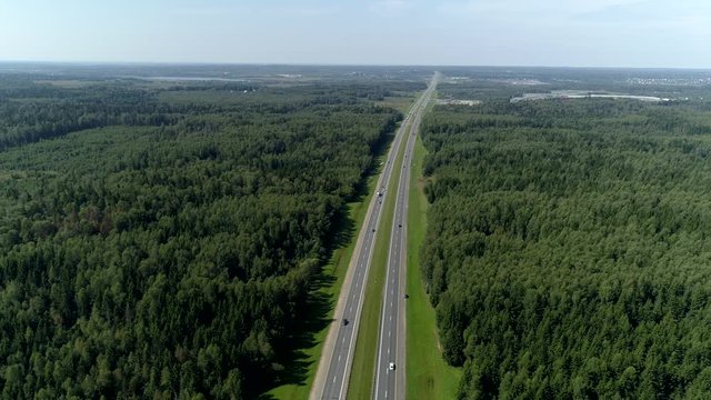 Helicopter Drift Country Highway Interstate Asphalt Two Straight Roads Out Of Town Two-way Go Into Distance Among Green Spring Forest. Active Road Traffic. Countryside Landscape Horizon. Sunny Day