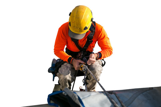 Close up pic of male rope access jobs  worker wearing yellow hard hat, long sleeve shirt, safety harness, working, at height abseiling down from high rise building with isolated white background 