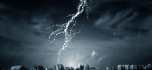 Lightnings at night city with stormy sky