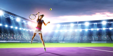 Young woman playing tennis in action