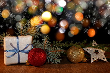Fototapeta na wymiar beautiful Christmas photo with twigs of spruce, Christmas toys on the background of falling snow