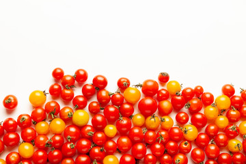 Red and yellow cherry tomatoes isolated on white background. Fresh bright organic vegetables.