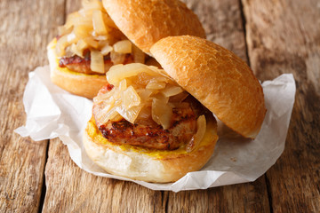 Chicago Pork Chop Sandwiches close-up on paper on the table. Horizontal, rustic