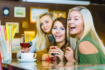 Women singing with microphone