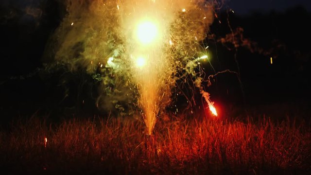 Fireworks on the dry grass. Dangerous behavior and cause of fire