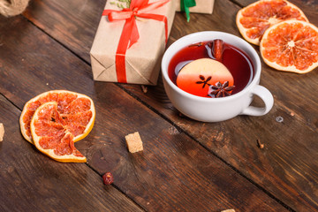 Christmas hot mulled wine with cinnamon cardamom and anise on wooden background