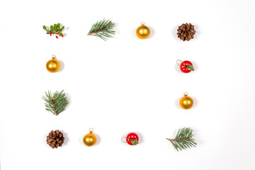 Creative flat lay of winter toys, berries, balls and cones on white background. Flat lay, top view. Holidays collection.