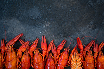 Red boiled crawfishes on table in rustic style, closeup. Lobster closeup.