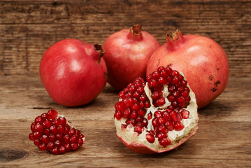 ripe pomegranate fruits on wooden table.