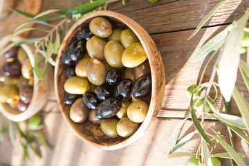 bowls with different kind of olives green olives, black olives, kalamata olives with olive oil