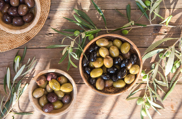 bowls with different kind of olives : green black kalamata olives with olive oil