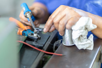 Soldering iron soldering a wire to an electrical component with smoke coming of it  lying on top of coloured wires