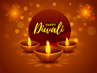 Illuminated oil lamps (Diya) on brown bokeh fireworks background for Happy Diwali celebration concept. Can be used as greeting card design.
