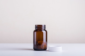 Dietary supplement bottles of a lid open set on a white background.