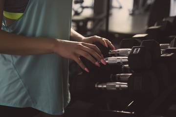 Women using dumbbell in gym