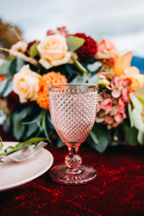 Vintage glass in boho style on the table of newlyweds