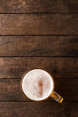 Beer glass on an old wooden table. Top view