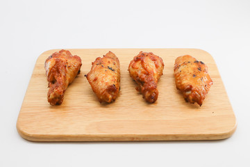 barbecue chicken wing on wooden chopping white background 