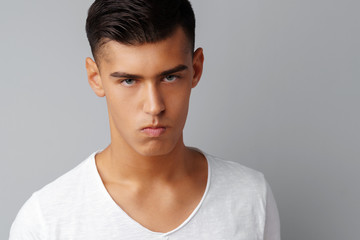 Portrait of angry irritated young man teenager