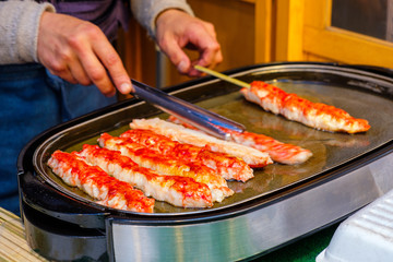 Fresh tender meat from the legs of a king crab blow torch in Tsukiji Market, Tokyo