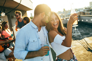 Happy young dancing couple having fun and enjoying party at summer - Powered by Adobe